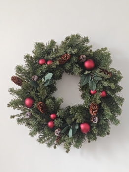 Christmas Wreath with Pine Needles, Magnolia Leaves, Pine Cones and Red Baubles