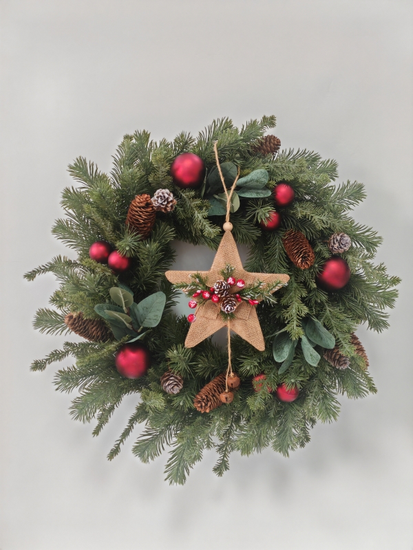 Christmas Wreath with Pine Needles, Magnolia Leaves, Straw Star Ornament and Red Baubles