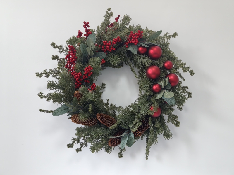 Christmas Wreath with Pine Needles, Magnolia Leaves, Red Berries and Red Baubles